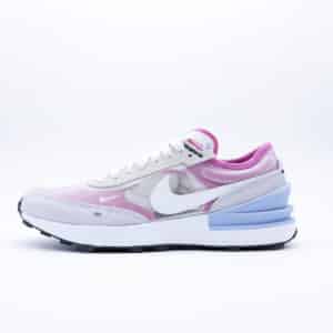 Tenis Nike Waffle One para mujer en tonos gris claro, blanco y morado, diseño deportivo con empeine de malla traslúcida y suela tipo waffle.