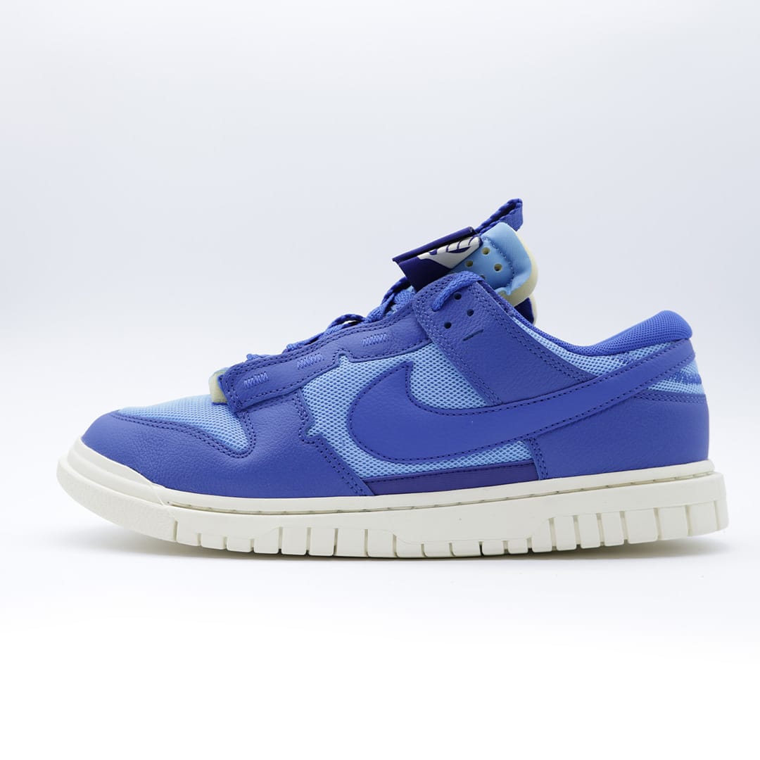 Tenis unisex Nike Air Dunk Jumbo edición "UNC". Diseño deconstruido con capas de malla y piel en tonos azul universitario y blanco.